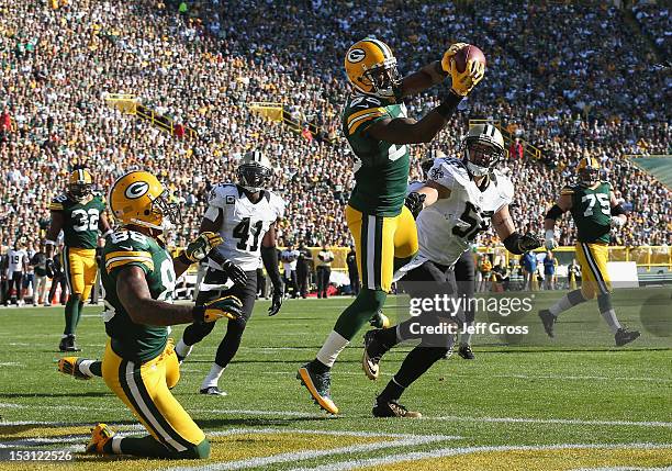 Wide receiver James Jones of the Green Bay Packers catches a pass for a touchdown in front of outside linebacker Scott Shanle of the New Orleans...