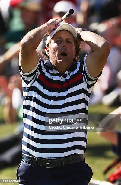 United States' Phil Mickelson reacts to missing a chip for birdie on the 17th hole while losing his match to Europe's Justin Rose as Europe rallied...