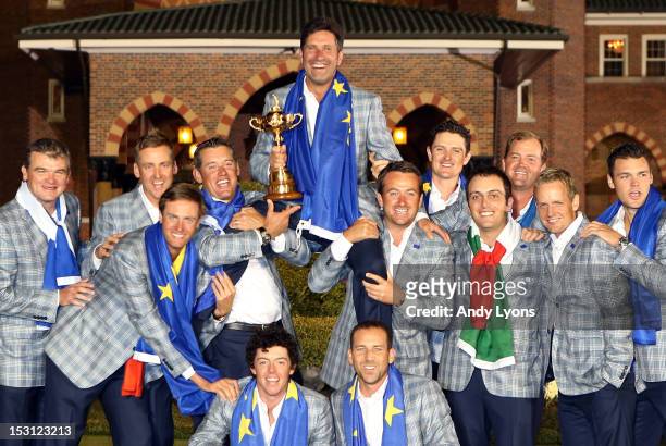 The European team hoist their captain Jose Maria Olazabal after Europe defeated the USA 14.5 to 13.5 at The 39th Ryder Cup at Medinah Country Club on...
