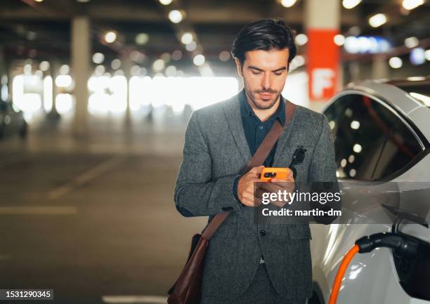 businessman charging an electric car - car sharing stock pictures, royalty-free photos & images