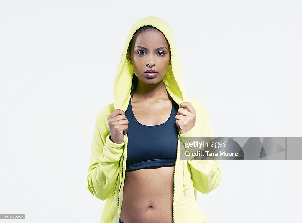 Sports woman holding hooded top