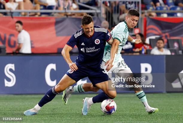New England Revolution forward Giacomo Vrioni holds off Atlanta United FC midfielder Matheus Rossetto during a match between the New England...