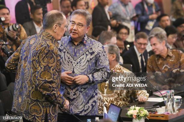 Russia's Foreign Minister Sergei Lavrov talks to South Korea's Foreign Minister Park Jin as US Secretary of State Antony Blinken sits prior to the...