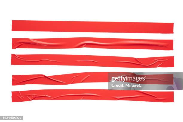 red duct tape long strips isolated on white - klebeband stock-fotos und bilder