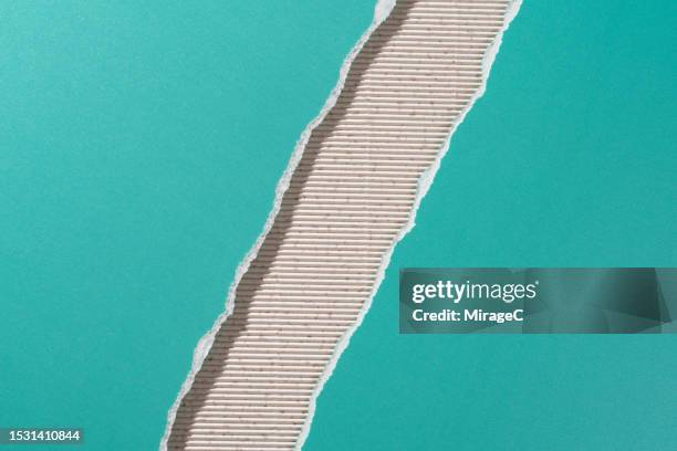turquoise colored paper torn in half on beige corrugated paper - cardboard edge stock pictures, royalty-free photos & images