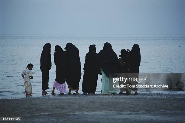 Group of women and girls on the beach at Half Moon Bay near Khobar city in Eastern Province, Saudi Arabia, 1990.