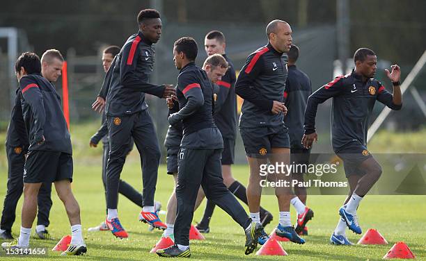 Danny Welbeck, Mikael Silvestre and Patrice Evra lead team-mates in training during a Manchester United training session at the Carrington Training...
