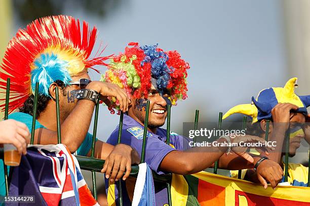 Supporters wear colourful wigs as they watch the action during the Super Eights Group 1 match between New Zealand and West Indies at Pallekele...