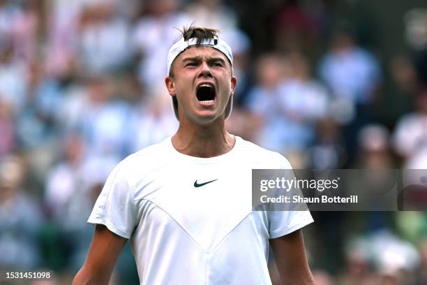 Holger Rune of Denmark celebrates winning match point against Grigor Dimitrov of Bulgaria in the Men's Singles fourth round match during day eight of...