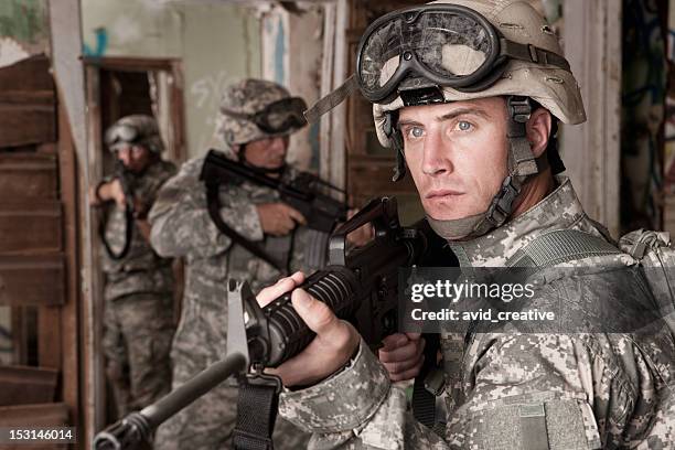 soldiers clearing an abandoned building - hitman stock pictures, royalty-free photos & images