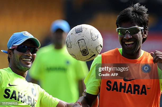 Indian cricketers Lakshmipathy Balaji , and Ashol Dinda play football during an ICC Twenty20 Cricket World Cup practice session at the R. Premadasa...