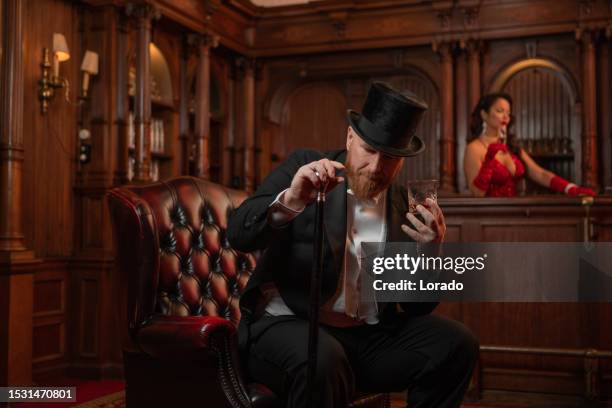 a handsome elegant 1920s style gentleman in a luxury stately home - gangster stock pictures, royalty-free photos & images