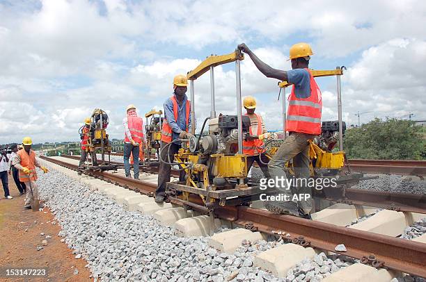 People are at work on a building site of the Abuja light rail project on September 20, 2012 in Abuja. President Goodluck Jonathan's government has...
