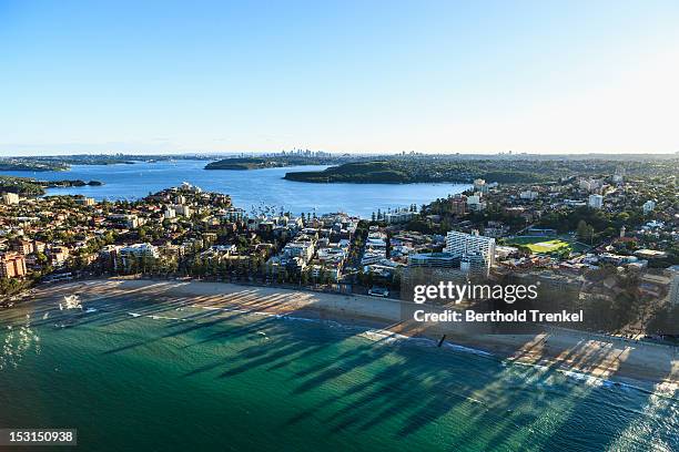 manly beach and a distant sydney skyline - manly beach stock pictures, royalty-free photos & images