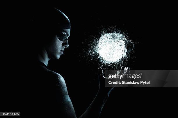 swimmer controlling ball of water - control stock pictures, royalty-free photos & images