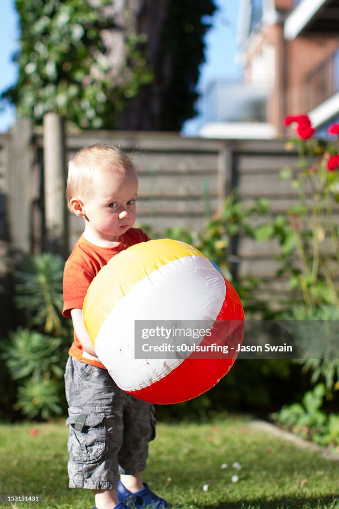 Boy holding beach ball