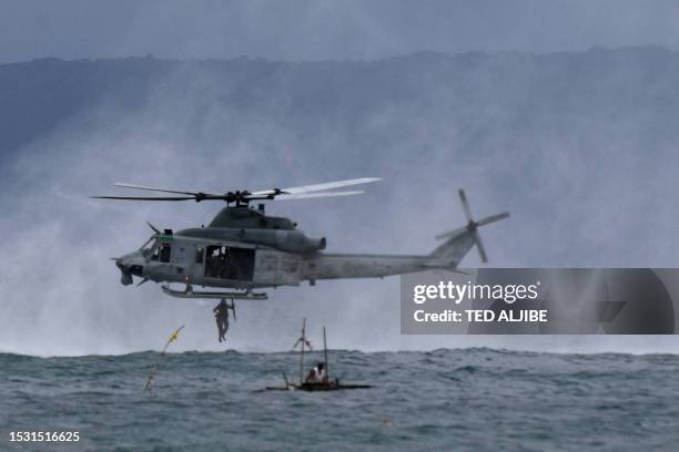 Philippines marine jumps off from a US marines UH-1Y Venom helicopter during a helocast and maritime patrol training exercise as part of the...
