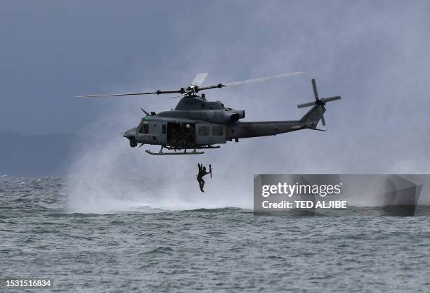 Philippines marine jumps off from a US marines UH-1Y Venom helicopter during a helocast and maritime patrol training exercise as part of the...