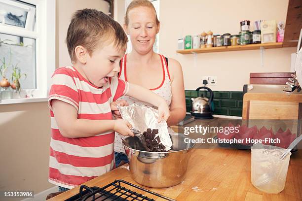 Mother and her young son baking