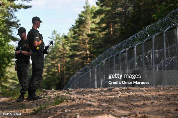 Lithuanian border guard officers patrol along the Belarus–Lithuania border on July 10, 2023 in Dieveniskes, Lithuania. Members and partner countries...