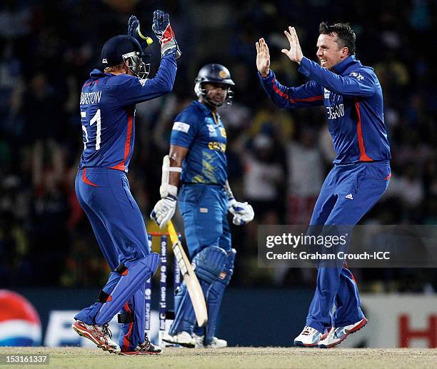 Jonny Bairstow and Graeme Swann of England celebrate after dismissing Kumar Sangakkara of Sri Lanka during the Super Eights Group 1 match between...