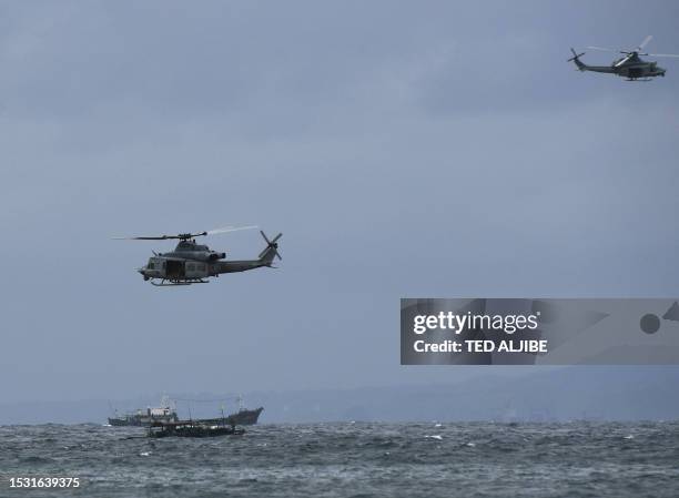 Marines UH-1Y Venom helicopters hover above Philippine fishermen during a helocast and maritime patrol training exercise as part of the semiannual...