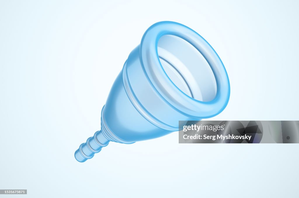 Close-up of a blue menstrual cup on a light blue background.