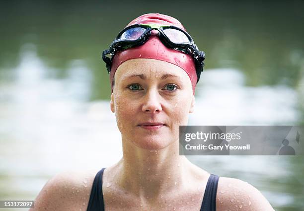 female wild swimmer in a river - swimming cap stock pictures, royalty-free photos & images