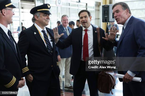 Sen. Mark Warner and Sen. Marco Rubio share a moment as Sen. Rubio passes through Ronald Reagan Washington National Airport prior to a news...