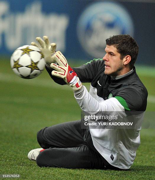 Celtic's goalkeeper Fraser Forster catches a ball during a training session at the Luzhniki stadium in Moscow on October 1, 2012 on the eve of an...