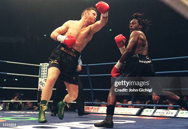 Steve Collins of Ireland swings and misses Nigel Benn, with a left hook, during the Benn v Collins rematch at the Nynex Arena in Manchester. Steve...