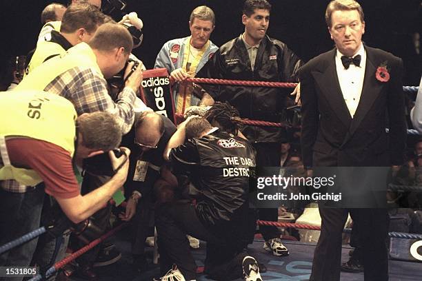 Nigel Benn is consoled after being retired by his cornermen at the end of the sixth round, signalling the end of his illustrious career. Promoter...