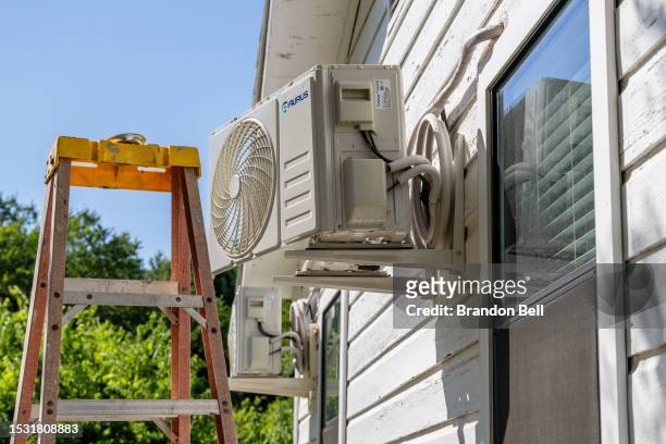 An air conditioning unit undergoes repair on July 10, 2023 in Austin, Texas. Record-breaking temperatures continue soaring as prolonged heatwaves...