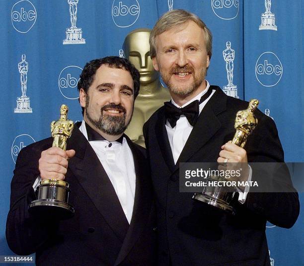 Oscar winners John Landau , Best Picture and James Cameron Best Picture, Director and Editor both for "Titanic", pose for photographers 23 March at...