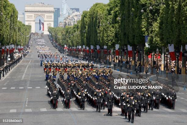 Pupils of the Ecole polytechnique march during the Bastille Day military parade on the Champs-Elysees avenue, with the Arc de Triomphe seen in the...