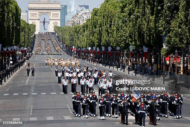 Pupils from Fire-fighters officers National graduate school march during the Bastille Day military parade on the Champs-Elysees avenue in Paris on...