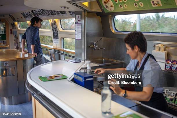 Traveller looks out of a window of the restaurant car on the return leg of the first Barcelona-Lyon train, operated by Renfe Operadora SC, outside...