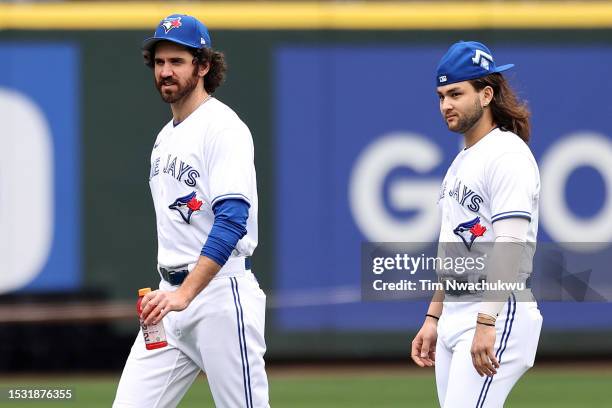 Jordan Romano and Bo Bichette of the Toronto Blue Jays look on during Gatorade All-Star Workout Day at T-Mobile Park on July 10, 2023 in Seattle,...