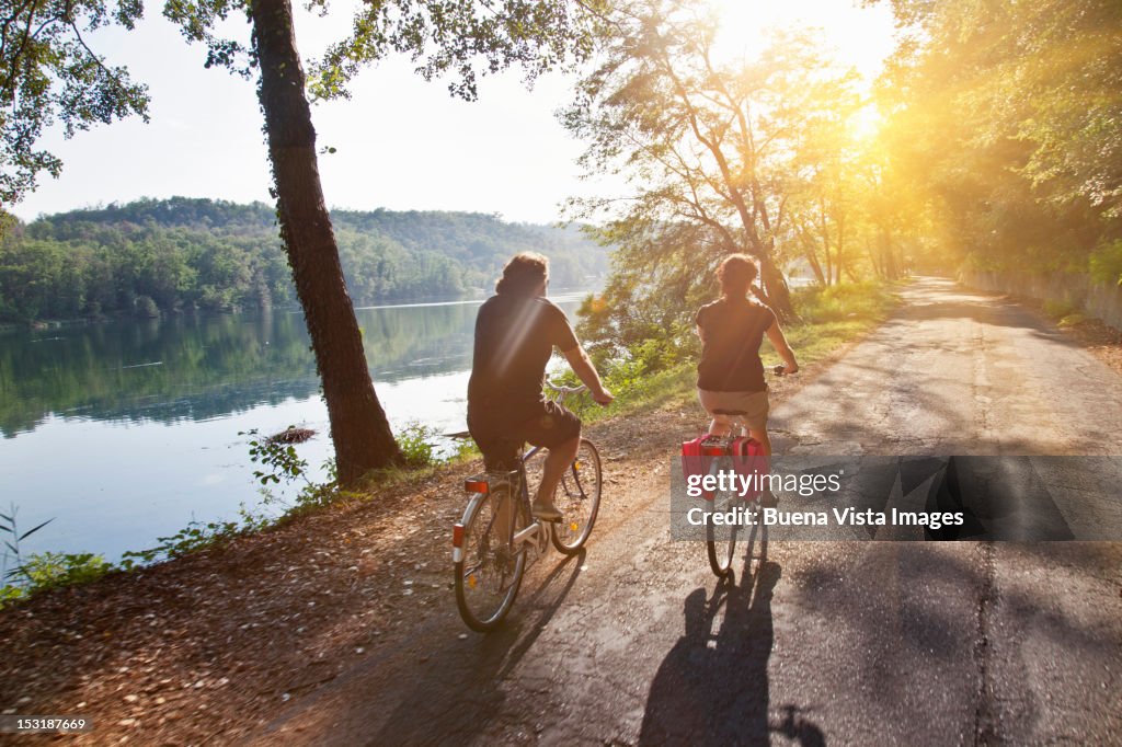 Couple on bicycle along a river