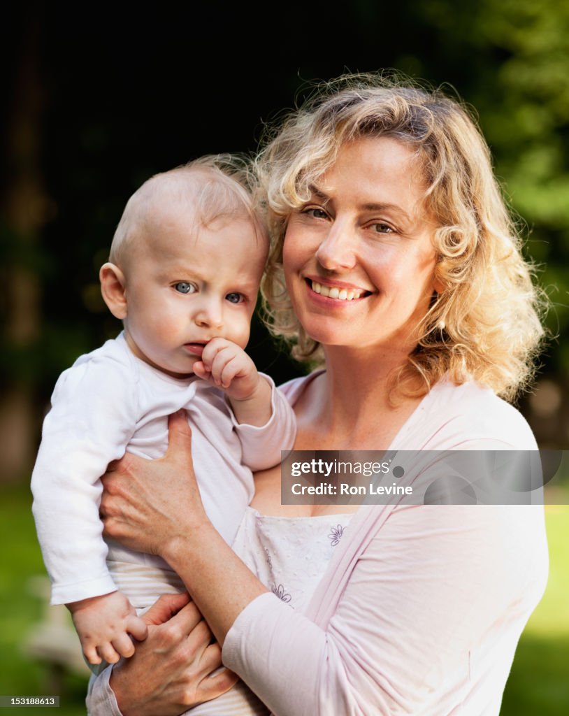 Mature woman with baby boy, portrait