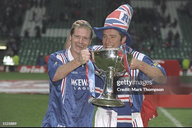 Paul Gascoigne and teammate Ally McCoist pose with the trophy after the Scottish Coca Cola cup final between Rangers and Hearts at Celtic Park in...