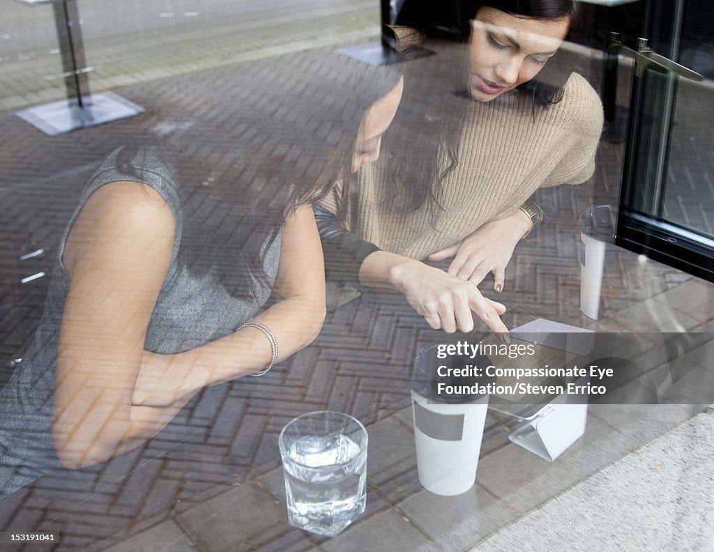 Businesswomen working in cafe with digital tablet