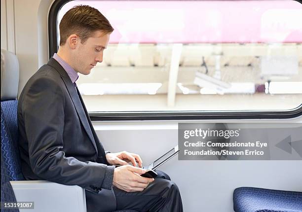Businessman On Train Using Laptop, Foto de stock