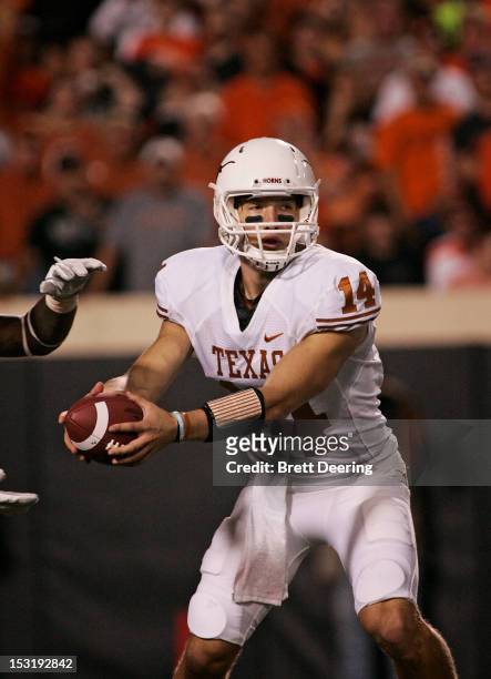 Quarterback David Ash of the Texas Longhorns looks to hand off against the Oklahoma State Cowboys on September 29, 2012 at Boone Pickens Stadium in...