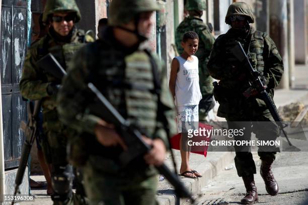 Brazilian navy soldiers patrol the "Maré" shantytown, during security operations in preparation for the upcoming municipal elections, in Rio de...