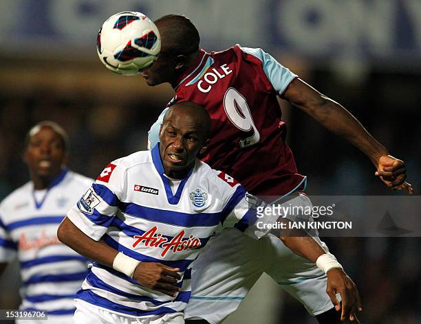 Queens Park Rangers' Cameroon player Stephane Mbia vies with West Ham United's Carlton Cole during an English Premier League football match between...