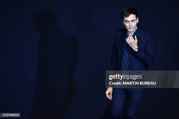 French-born designer Hedi Slimane for Saint Laurent acknowledges the public during the Spring/Summer 2013 ready-to-wear collection show on October 1,...