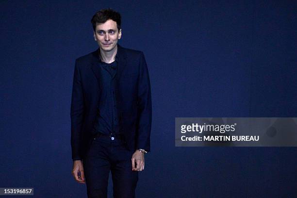 French-born designer Hedi Slimane for Saint Laurent acknowledges the public during the Spring/Summer 2013 ready-to-wear collection show on October 1,...