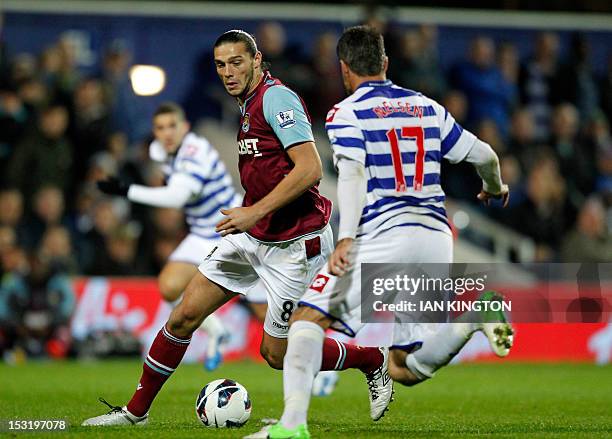 West Ham United's Andy Carroll vies with Queens Park Rangers' New Zealand player Ryan Nelsen during an English Premier League football match between...