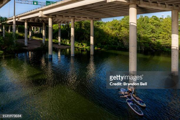 People rest on river boards in the Colorado River on July 10, 2023 in Austin, Texas. Record-breaking temperatures continue soaring as prolonged...